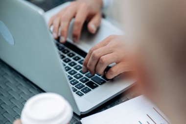 İş adamı finansal verileri olan bir dizüstü bilgisayarda çalışıyor..