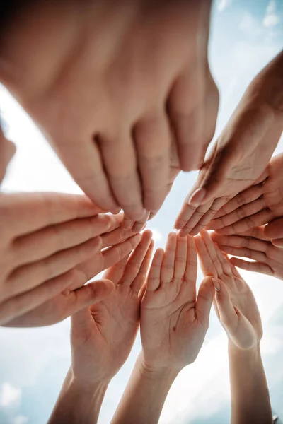 Group of young business people joining their palms in a circle. — Stock Photo, Image