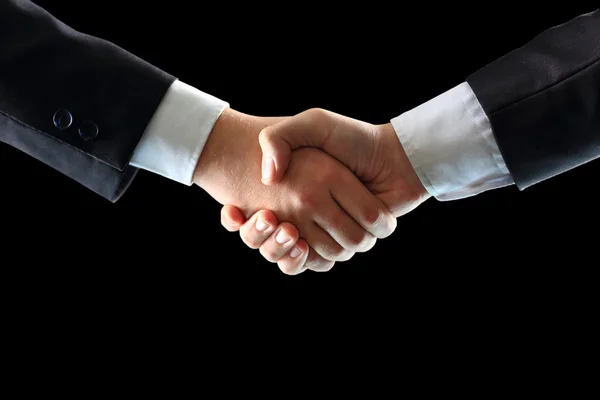 Handshake - Hand holding on black background — Stock Photo, Image