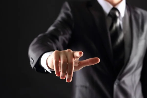 Businessman hand pressing an imaginary button on virtual screen — Stock Photo, Image