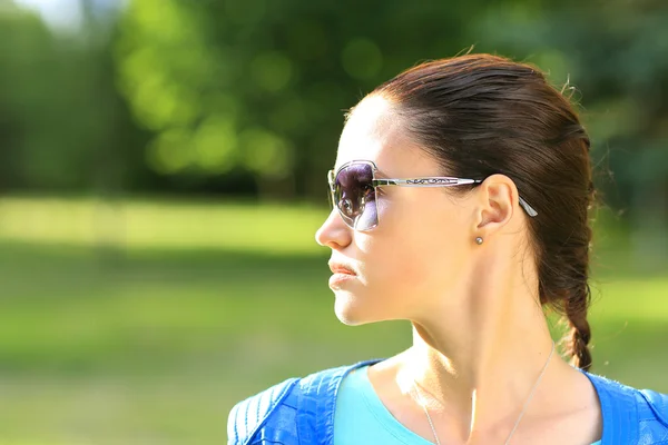 Beautiful sexy woman on the nature in black sunglasses — Stock Photo, Image