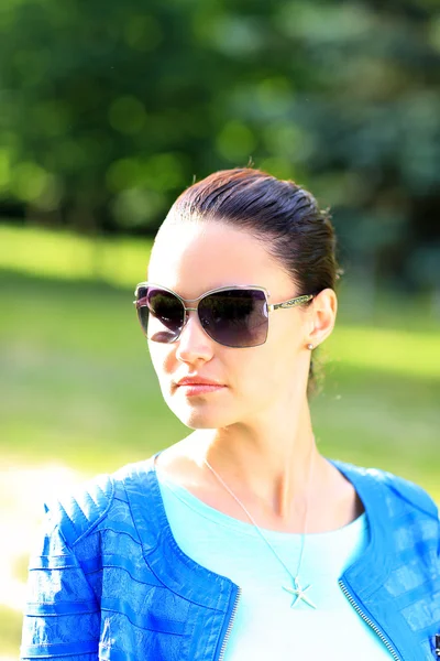 Beautiful sexy woman on the nature in black sunglasses — Stock Photo, Image