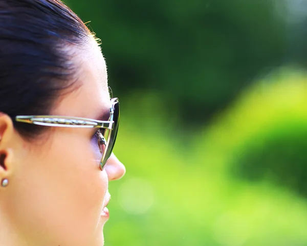 Beautiful sexy woman on the nature in black sunglasses — Stock Photo, Image