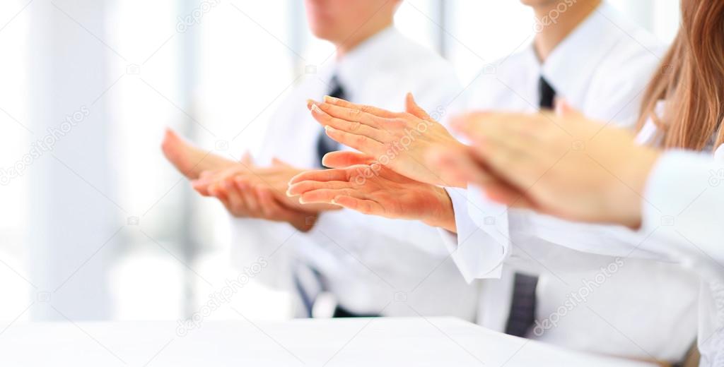 Close-up of business people clapping hands. Business seminar concept
