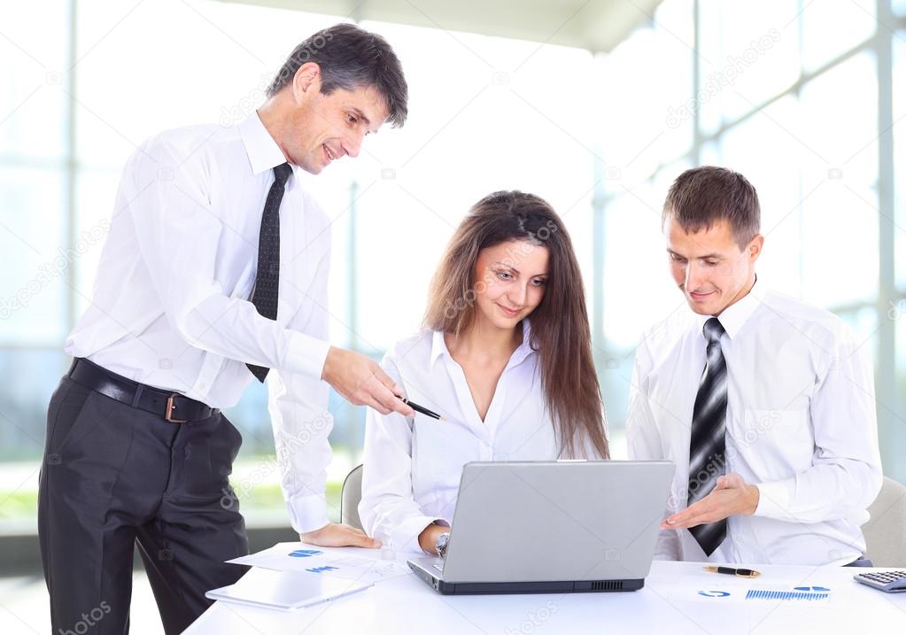 Business, technology and office concept - smiling female boss talking to business team