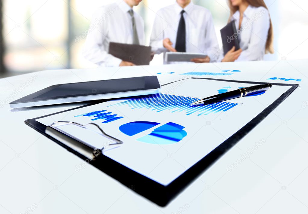 Close-up of business document in touchpad lying on the desk, office workers interacting