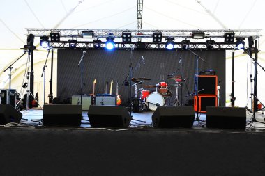 An empty Stage Before the Concert with floodlight and musical instruments