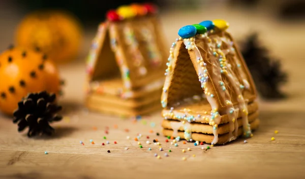 Beautiful gingerbread house on wooden background with Christmas decorations — Stock Photo, Image