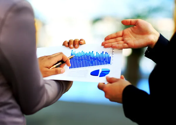 Close-up of graphs and charts analyzed by business people — Stock Photo, Image