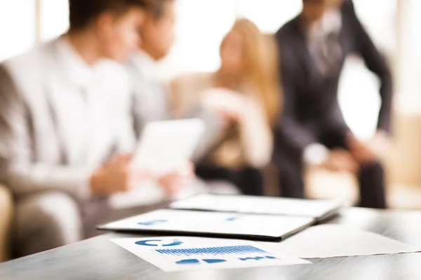 Image of business documents with working team communicating at background — Stock Photo, Image