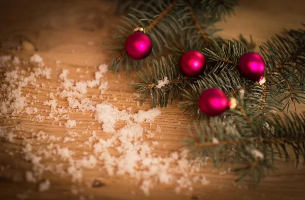 Primer plano de bolas rojas de Navidad y ramas de abeto sobre fondo de madera . — Foto de Stock