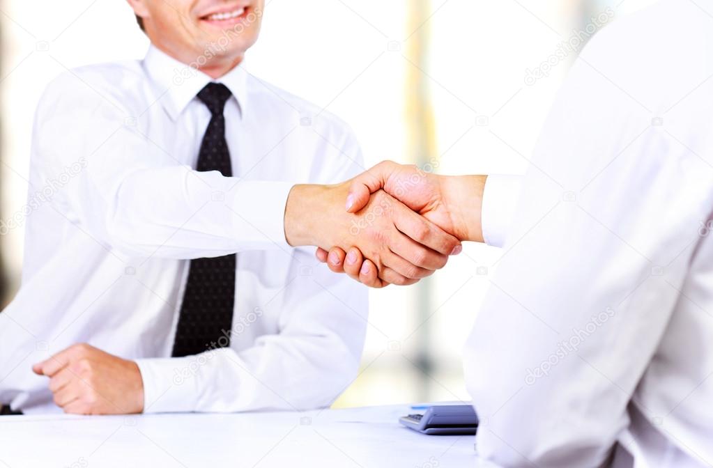 Close up image of business handshake at meeting. Partnership concept