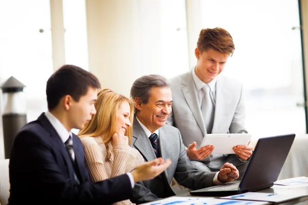 Serious business team with tablet pc computers, documents having discussion in office — Stock Photo, Image