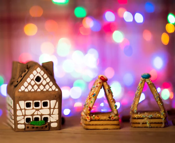 Fairy Christmas house cake with candle light inside, narrow depth of field and background lights — Stock Photo, Image