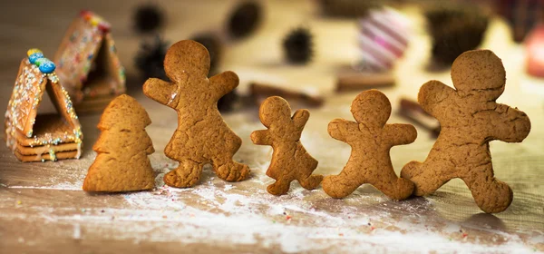 Gingerbread men on the wooden floor with Christmas decorations