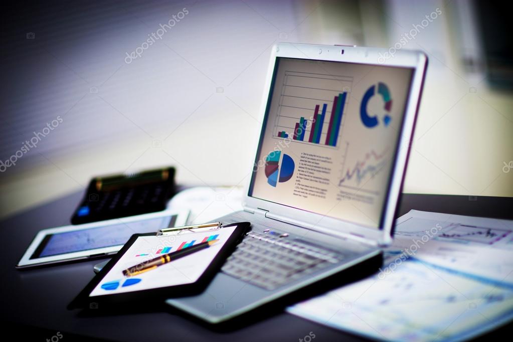 Businessman analyzing investment charts with laptop. Accounting