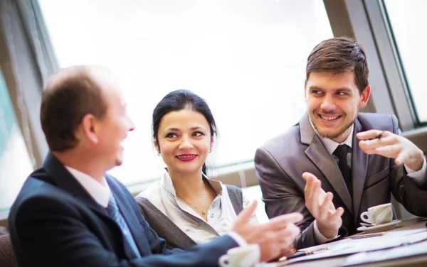 Portrait of smart business partners communicating at meeting — Stock Photo, Image