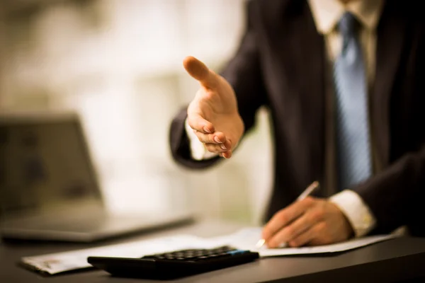 Portrait of a successful businessman giving a hand — Stock Photo, Image