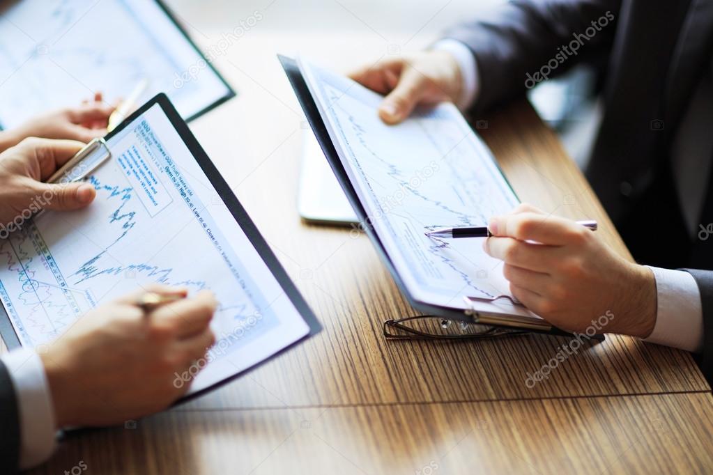 Banking business or financial analyst desktop accounting charts, pens indicates graphics