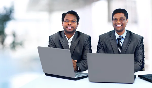 Interracial business team working at laptop in a modern office — Stock Photo, Image