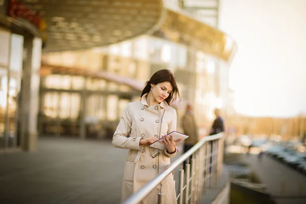 Portrait of business woman with tablet and with people in the background — Stock Photo, Image