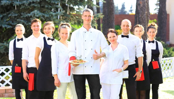 Large group of waiters and waitresses standing in row. — Stock Photo, Image