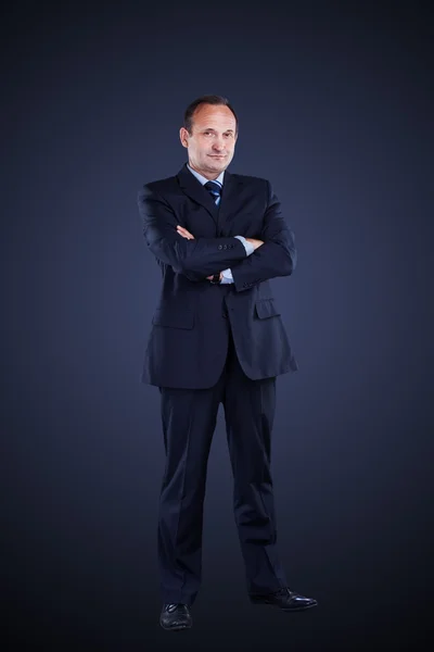 Confident businessman isolated on a dark background. — Stock Photo, Image