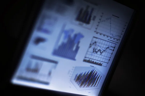 Monitor on a black background with graphs and charts — Stock Photo, Image