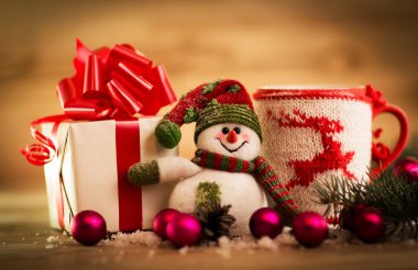 Bir fincan çay ya da kahve. Tatlılar ve Baharatlar. Kardan adamla Noel süslemesi. Ahşap Arkaplan.