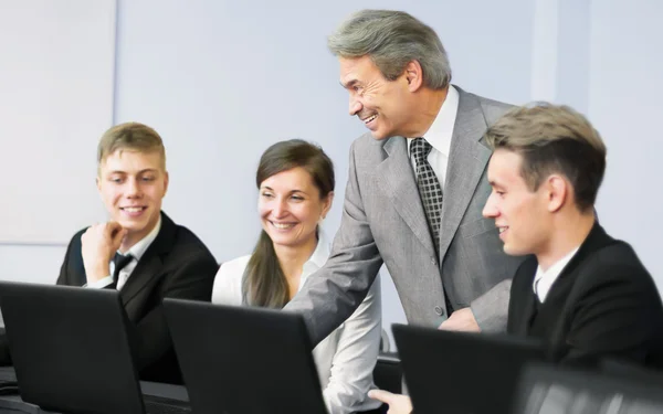 Business team working together on laptop in the office — Stock Photo, Image