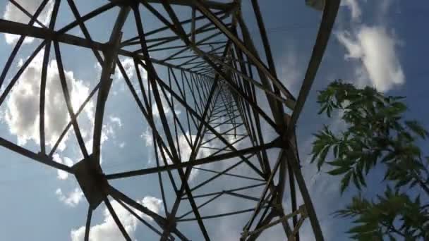 Electrical pylon construction against blue cloudy sky, time lapse 4K — Stock Video