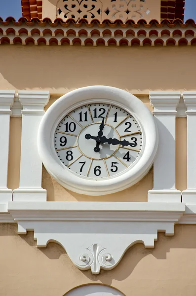 Street clock on house facade Stock Photo