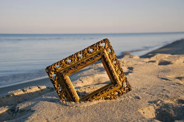 vintage golden picture frame on sea resort beach