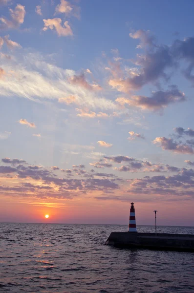 Beautiful sea sunrise and lighthouse on pier — Stock Photo, Image