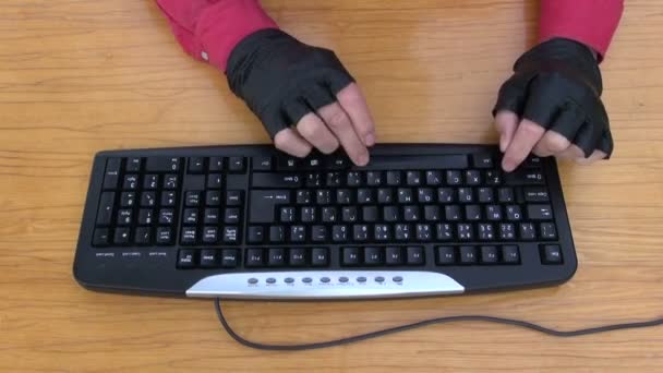 Hacker hands with glove working with computer keyboard — Stock Video