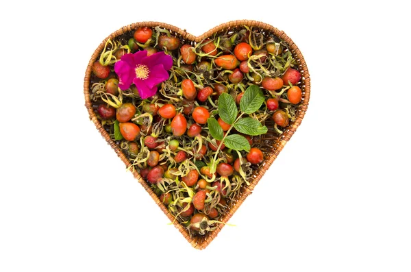 Fresh summer rose hips in heart form wicker basket isolated — Stock Photo, Image