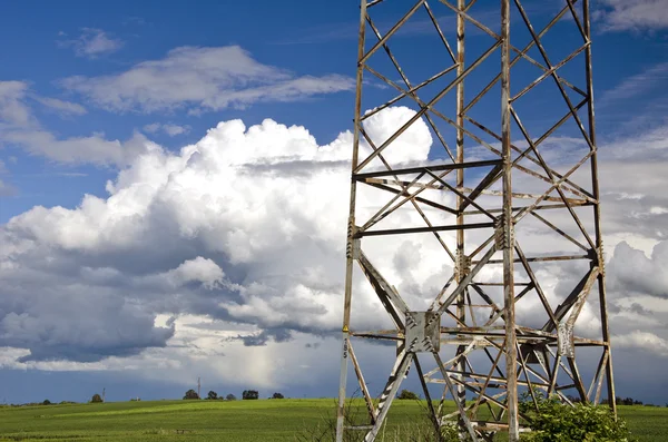 Electricidad poste de metal de alto voltaje en campo agrícola de verano —  Fotos de Stock