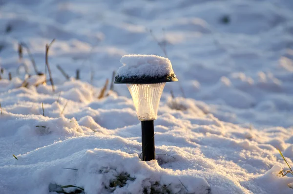 Lâmpada de jardim solar nevado no inverno — Fotografia de Stock