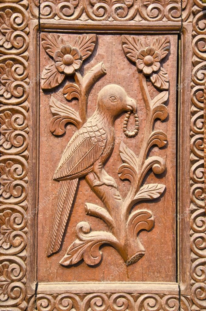 Ornate carved wood door fragment with bird relief — Stock ...