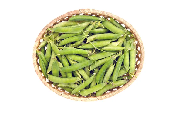 Fresh sweet pea pods in wicker basket — Stock Photo, Image