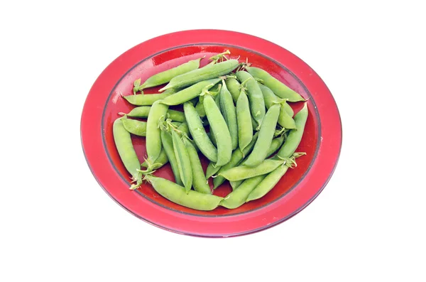 Fresh sweet vegetable pea pods in red ceramic plate — Stock Photo, Image