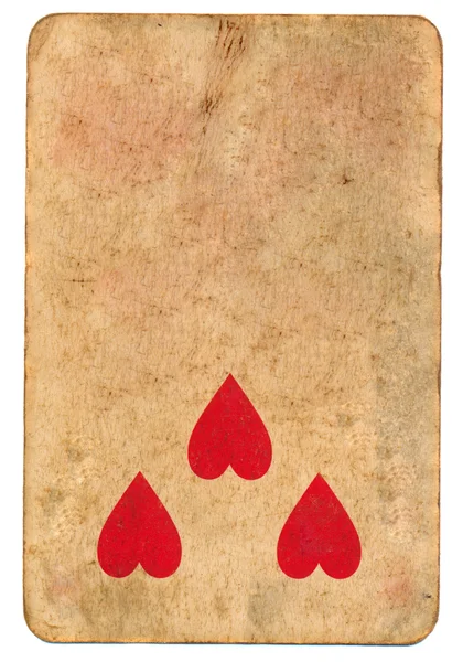 Three red heart symbol on old playing card paper background — Stock Photo, Image