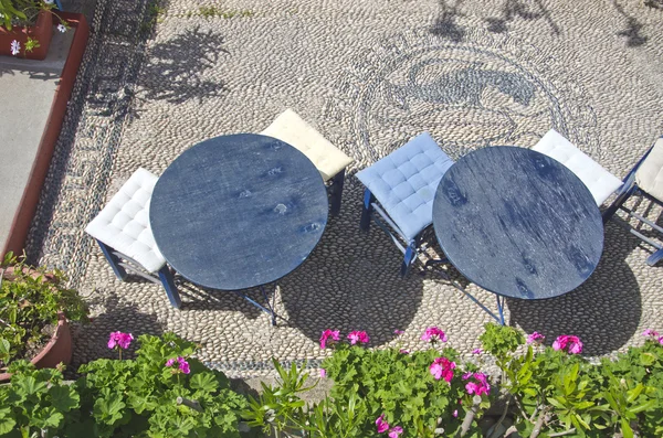 Two round tables with soft stools in Greece — Stock Photo, Image