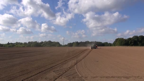Agriculture tractor sowing wheat seeds in field — Stock Video