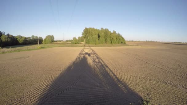 Autumn evening electric tower shadow on plowed  field. Timelapse 4K — Stock Video