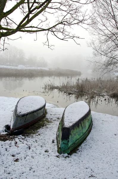 Deux bateaux renversés sur la neige d'hiver — Photo