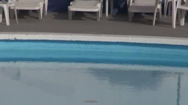 Plaj şemsiyeleri avuç yapılmış bırakır ve Yüzme Havuzu yuvarlak