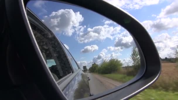 Landscape of countryside from going car with reflection in rear view mirror — Stock Video