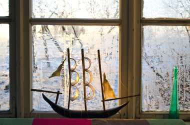 Model of a ship on frosted window in the morning clipart
