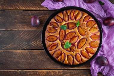 Ahşap arka planda lezzetli erikli kek. Ev yapımı erikli turta. Üst görünüm